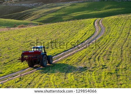 tractor on a country road at the daybreak