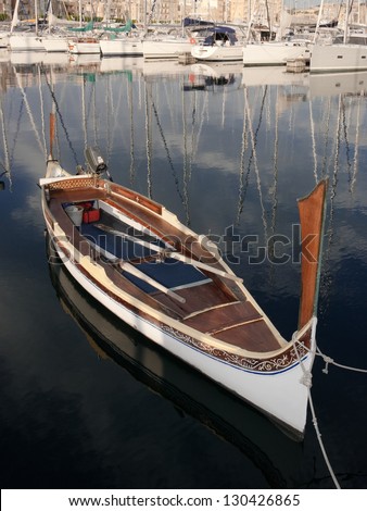 traditional row boat moored in Senglea Marina, Malta