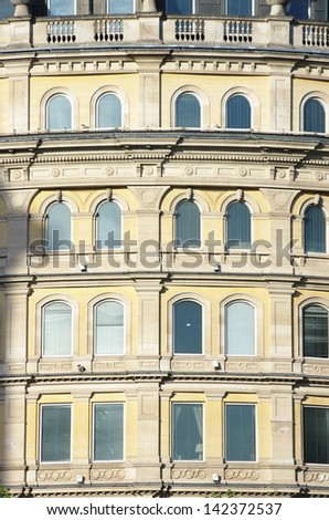 arched windows of building facade in Trafalgar Square, London