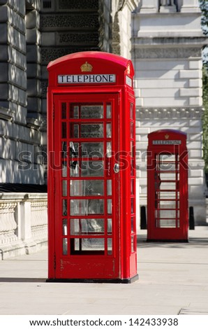 two red phone boxes old style in London in row (shallow depth of field)