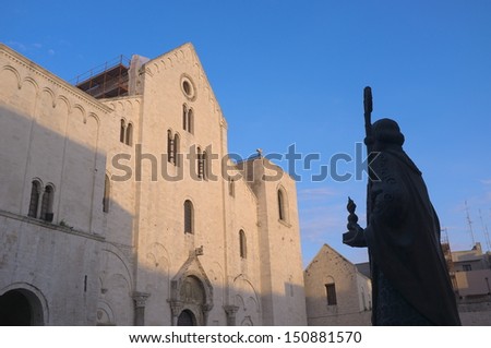 basilica and silhouette statue of St. Nicholas thaumaturge in old Town of Bari