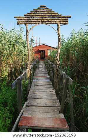 boardwalk to red wooden shack for fishing on the Ada Bojana river, Montenegro