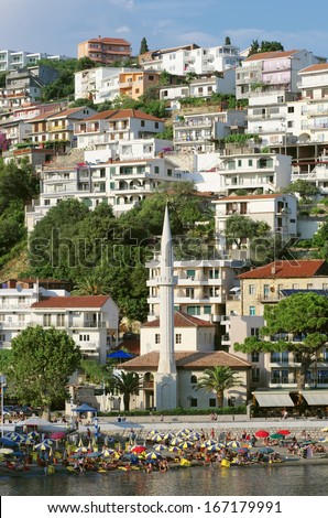minaret of the mosque on the crowded "Mala Plaza" beach in Ulcinj downtown, Montenegro