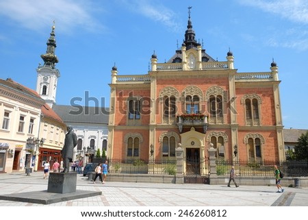 NOVI SAD, SERBIA - AUGUST 02: statue J. J. Zmaj and neo-classical architecture of Vladicin Court Palace of Bishop in Novi Sad. Shot in 2014