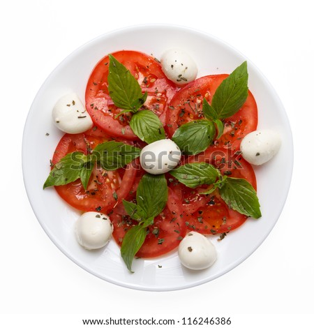 caprese salad on plate directly above isolated on white background