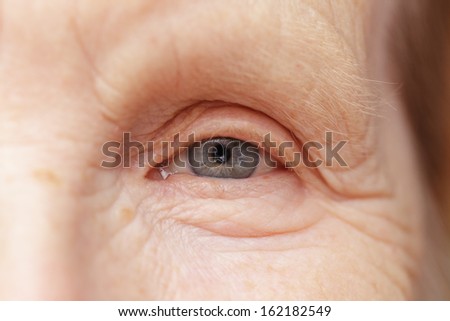 old woman gray eye, very close up photo