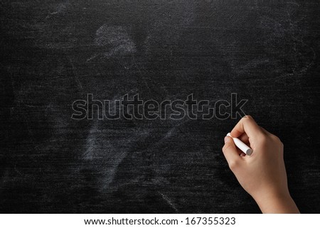 Female Teen Hand To Draw Something On Blackboard With Chalk