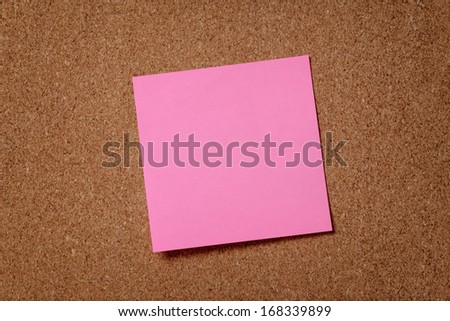pink reminder sticky note on cork board, empty space for text
