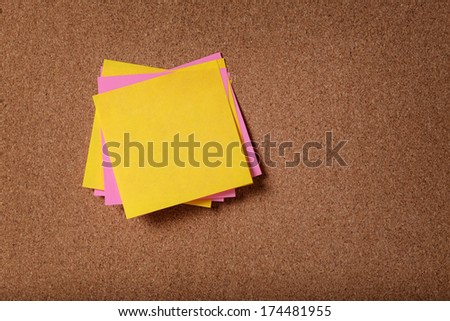 bunch of empty sticky notes on cork board