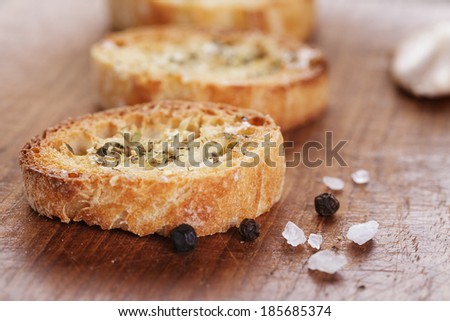 crostini with olive oil and garlic, on cutting board