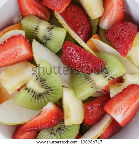 fresh mix fruit salad with strawberry, kiwi and peach, close up background