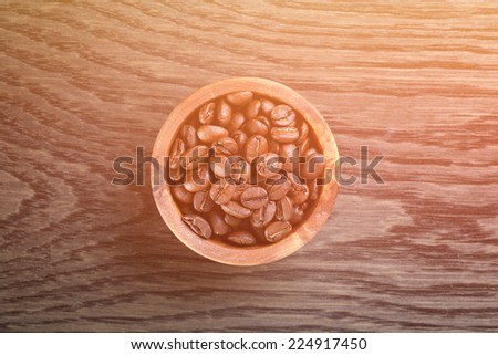 freshly roasted arabica coffee beans in bowl, strong light