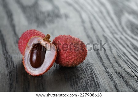ripe lychee fruits, on old oak table