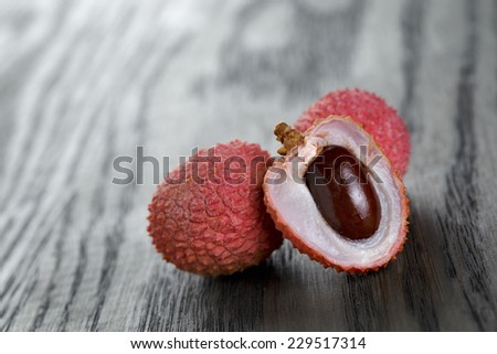 ripe lychee fruits, on old oak table