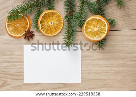 christmas tree branch on oak table, rustic background