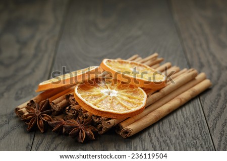 true cinnamon sticks and dried oranges, on rustic oak table