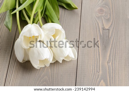 white tulips on rustic wood table, springtime flowers