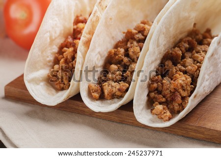 Closeup of three tacos with minced meat, fast food