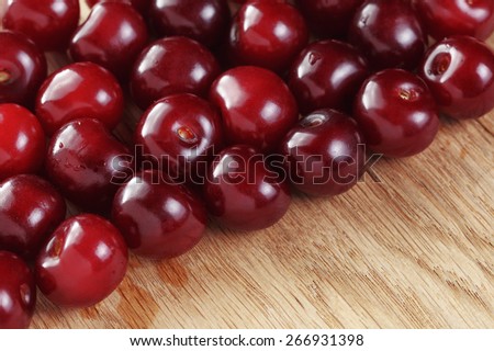 ripe cherries on wood table organic food background