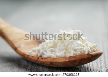 cottage cheese in olive wood spoon