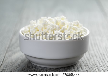 cottage cheese in white bowl on old table