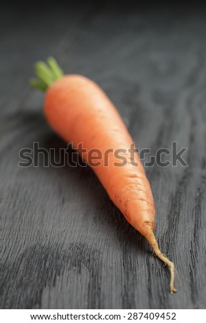 fresh carrot on old oak table, organic vegetables