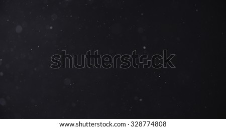 flour dust particles on black background, motion blur
