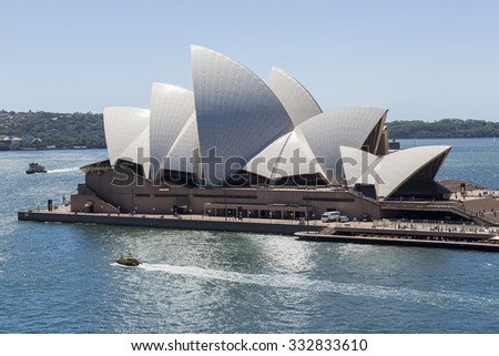 SYDNEY, AUSTRALIA - FEBRUARY 03, 2014: Sydney ferries pass Opera House, The Opera House opened in October 1973 and was designed by Jorn Utzon.