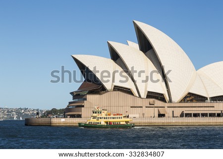 SYDNEY, AUSTRALIA - FEBRUARY 03, 2014: Small Sydney ferry passes Opera House, The Opera House opened in October 1973 and was designed by Jorn Utzon.