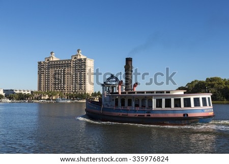 SAVANNAH, GEORGIA/USA - OCTOBER 23, 2014: Ferry boat taxi passes convention center. Free of charge water taxis cross the Savannah river to Hutchinson Island.