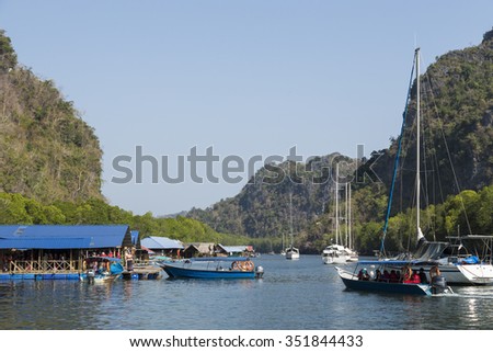 LANGKAWI, KEDAH/MALAYSIA - FEBRUARY 12, 2015: Unidentified tourists visit Paksu fish farm in the Kilim Karst Geoforest park. The Geopark was endorsed in 2007 by UNESCO.