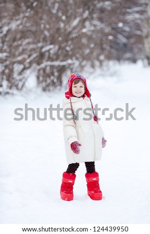 Small girl playing with snow