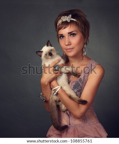 Young woman with siamese cat