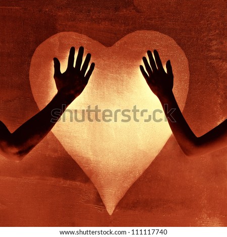Silhouette male and female hands touching painted heart on concrete wall