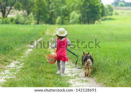Little Girl With Dog Running On The Road To The Picnic