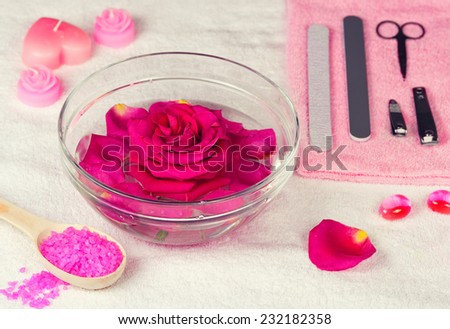 Place for manicure, bowl of water with rose flower
