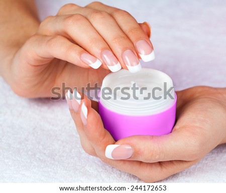 Female hands holding jar of cream