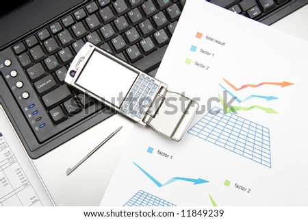 notebook, mobile and graphics on the desk
