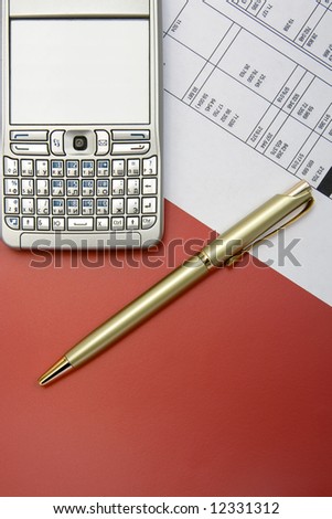 finance balance with  gold pen  and mobile