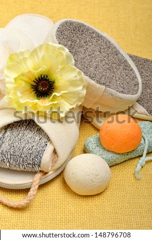 Natural bath sponges, bath slippers, pumice, bath bombs, salt on the yellow background