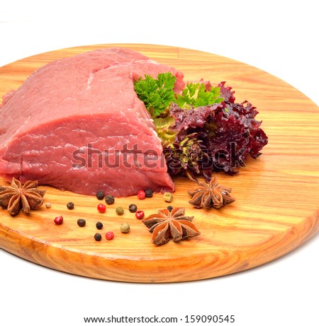 Raw beef and lettuce on the wooden board isolated on white