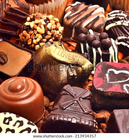 assortment of chocolate sweets and coffee grains background