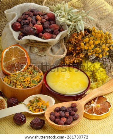 Calendula flower, oats, immortelle flower, tansy herb, honey, wild rose, dried lemon on sacking background