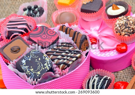 Belgian chocolate handmade chocolate candies in different shapes and colors on sacking background