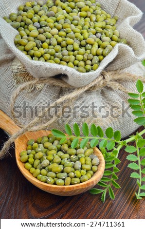Chickpea varieties in a burlap bag on a wooden background