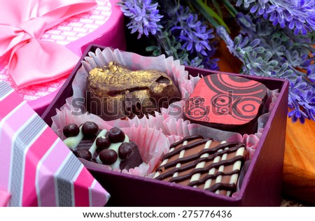 Assortment of chocolate sweets in gift boxes, lavender
