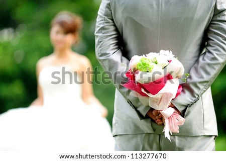 Groom holding wedding flower bouquet