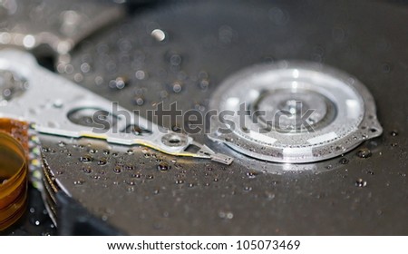 Hard disk drive with drops of water on it, close-up