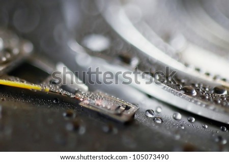 Hard disk drive with drops of water on it, close-up
