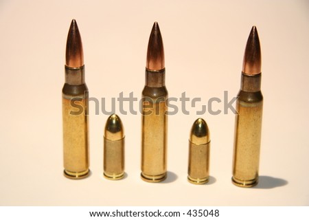 Rifle and pistol bullets lined up next to each other